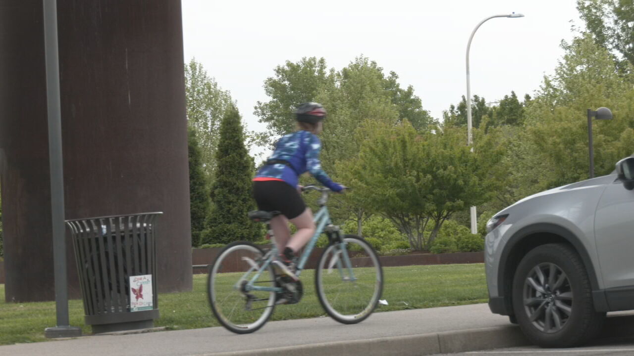 Sianna Malone rides her bike under the Big Four Bridge